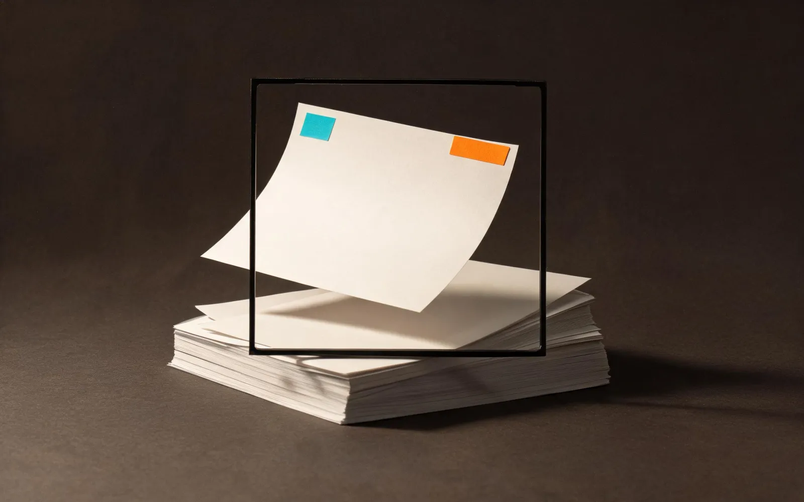 A blank assessment sheet passing through a black review frame